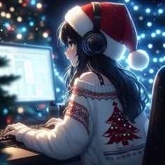 a woman wearing headphones sitting in front of a computer with a christmas tree on it