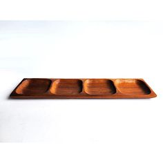 a wooden tray with four compartments on it