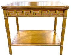 a wooden table with an intricate design on the top and bottom shelf, against a white background