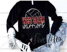 a black shirt with the words west salem in red and white on it next to ripped jeans