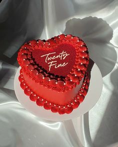 a heart shaped cake sitting on top of a white plate