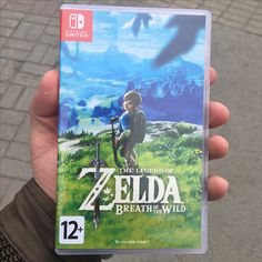 the legend of zelda breath of the wild nintendo wii game in someone's hand