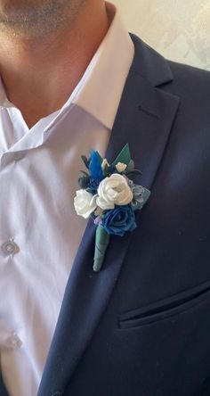 a man in a suit with a boutonniere on his lapel