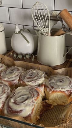 a box filled with cinnamon rolls sitting on top of a table