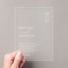 a person holding up a clear card with the words, britain and grayson on it