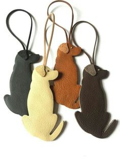 three leather key chains with cats on them