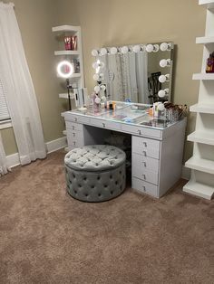 a bedroom with a vanity, stool and mirror