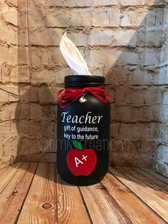 a teacher jar with an apple on it and a paper towel sticking out of the top