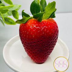 a close up of a strawberry on a plate