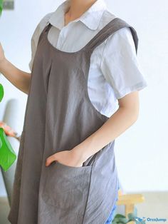 a woman holding a green plant in her hand