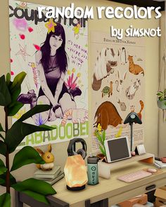 a computer desk with various items on it in front of a poster and potted plant