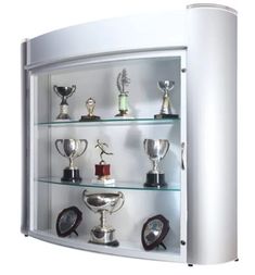 a white wall mounted display case with many trophies