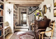 the hallway is decorated with bookshelves and antique furniture