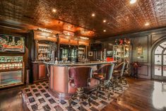 an elegant home bar with lots of stools