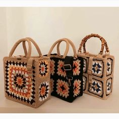 three handbags are shown with different designs on them