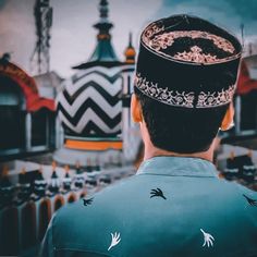 a man wearing a crown standing in front of a building