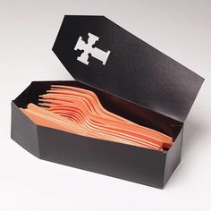 an open black box filled with lots of orange folders on top of a white table