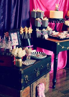 a table topped with lots of cake and cupcakes on top of wooden boxes