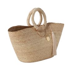 A shopper bag with eye-catching details that include bold circular handles and a cotton tassel accent. Crafted from lightweight flat weave natural palm with cotton details in natural or high-contrast black. Click images for greater detail. Product Overview: Material: Palm/Cotton Size: 20"L x 11"H Neutral Straw Bag With Braided Handles For Shopping, Natural Color Straw Bag With Tassels, Chic Handwoven Beach Bag With Round Handle, Chic Natural Beach Bag For Market, Chic Natural Beach Bag With Round Handle, Chic Natural Crochet Bag With Tassels, Natural Crochet Bag With Bamboo Handle For Shopping, Casual Beach Bag With Round Handle In Natural Color, Natural Color Straw Bag With Round Handle For Shopping