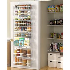 a refrigerator door is open and it has food in the bottom shelf, along with two bins on both sides