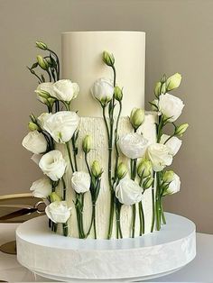 there is a white cake with flowers on it