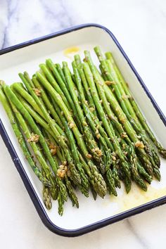 asparagus on a white plate with brown flecks