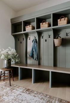 a room filled with lots of wooden lockers and baskets on top of each shelf