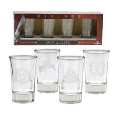 six shot glasses in a wooden box with an arrow and viking emblem on the front