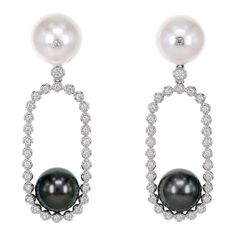 Inspired by Yin and Yang concept, the earring has 18.55 carat of black Tahitian Pearl and 28.30 carat of white South Sea Pearl. On the south sea pearl, we have embedded 2 pieces of white diamond in our trademark ' Stone in Stone ' design. South Sea Pearl Necklace, Pearl Party, Conch Pearl, White Pearl Earrings, Tahitian Pearl Necklace, Pearls Jewelry, Black Pearls, Tahitian Black Pearls, White Pearl Earring