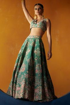 Rama green attached cancan lehenga crafted in raw silk material with all over floral, paisley embroidery in resham, zardozi work and badla texture work. Paired with a padded, resham and zardozi embroidered blouse with plunge scalloped neckline. Comes along with a dupatta
Components: 3
Pattern: Embroidery
Type Of Work: Resham, Zardozi, Floral
Neckline: Plunging Neck
Sleeve Type: Sleeveless
Fabric: Lehenga and Blouse: Raw Silk, Dupatta: Organza.
Color: Green
Other Details: 
Lehenga:
Length: 46 inc Green Sleeveless Choli For Festivals, Sleeveless Green Choli For Festivals, Green Choli With Cutdana For Reception, Green Pallu Gown For Reception, Green Sleeveless Choli With Pallu, Sleeveless Green Choli With Pallu, Green Reception Gown With Pallu, Traditional Green Sleeveless Choli, Green Sleeveless Designer Choli