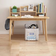 a wooden desk with a book shelf and storage bin underneath it, next to a bookshelf