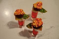 four small cups filled with food on top of a table