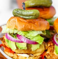 a white plate topped with sandwiches and pickles