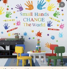 a child's playroom with colorful hand prints on the wall