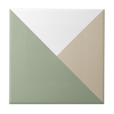 a white, green and beige wall tile with an irregular design on the bottom corner