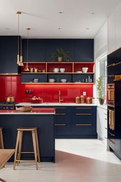 a kitchen with blue cabinets and red backsplash, gold trim on the countertops