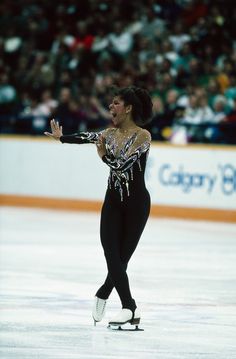 a female figure skating on an ice rink