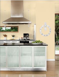 a modern kitchen with stainless steel appliances and glass doors on the cabinets, counter tops and drawers