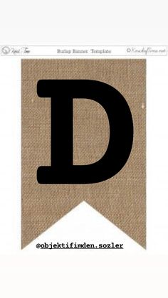 the letter d is made out of burluck paper and has a black font on it