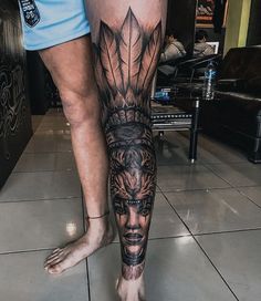 a man's leg with tattoos on it