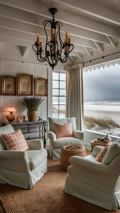 a living room filled with furniture and a chandelier hanging over the top of it