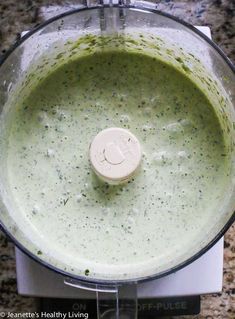 a food processor filled with broccoli and something green