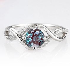 a ring with a blue diamond surrounded by white diamonds