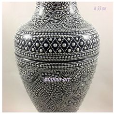 a large vase with intricate designs on the top and bottom, sitting in front of a white background