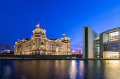 a large building sitting next to a body of water