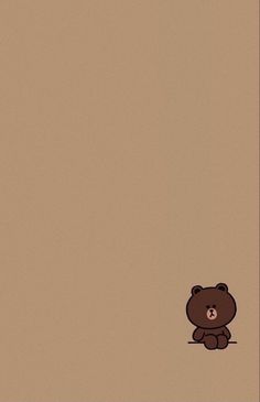 a brown teddy bear sitting on the ground