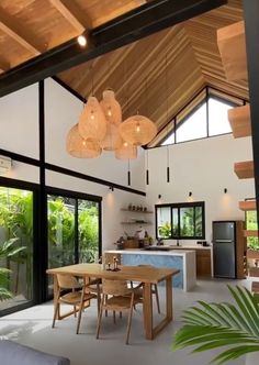 an open concept kitchen and dining area with wood ceilinging, large windows, and wooden furniture