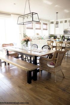 a dining room table with chairs and a bench