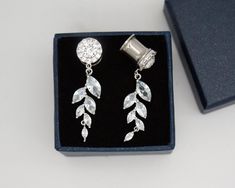 a pair of earrings is sitting in a box