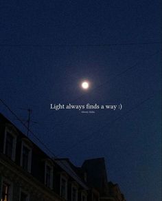 the moon is shining brightly in the sky above some buildings at night with an inspirational quote written below it